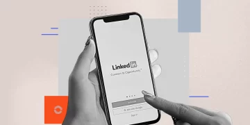 A LinkedIn post on a laptop screen with an AI chatbot reflected in the user’s glasses.