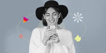 A YouTube Shorts creator filming a cozy fall outfit montage in a leaf-covered park.