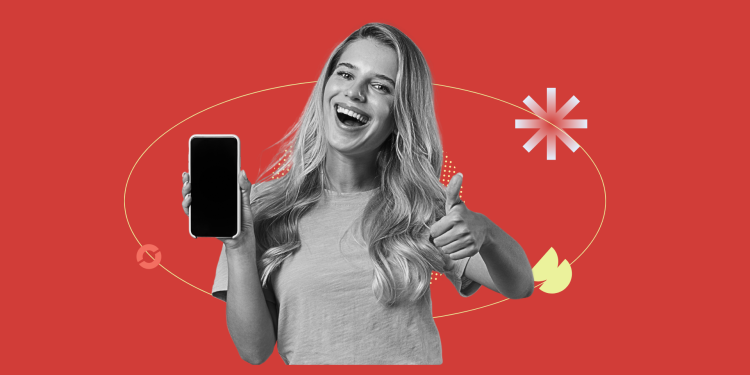 A YouTube Shorts creator filming a cozy fall outfit montage in a leaf-covered park.