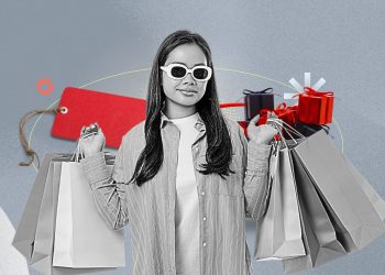 A dimly lit laptop screen showing Black Friday deals with a tired person scrolling