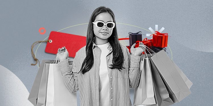 A dimly lit laptop screen showing Black Friday deals with a tired person scrolling