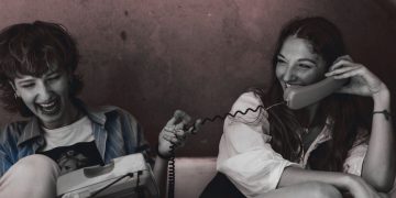 A creator showcasing an analog lifestyle with vintage iPod, magazines, and crafting tools